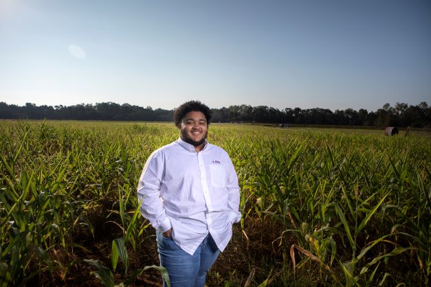 William stands in corn field