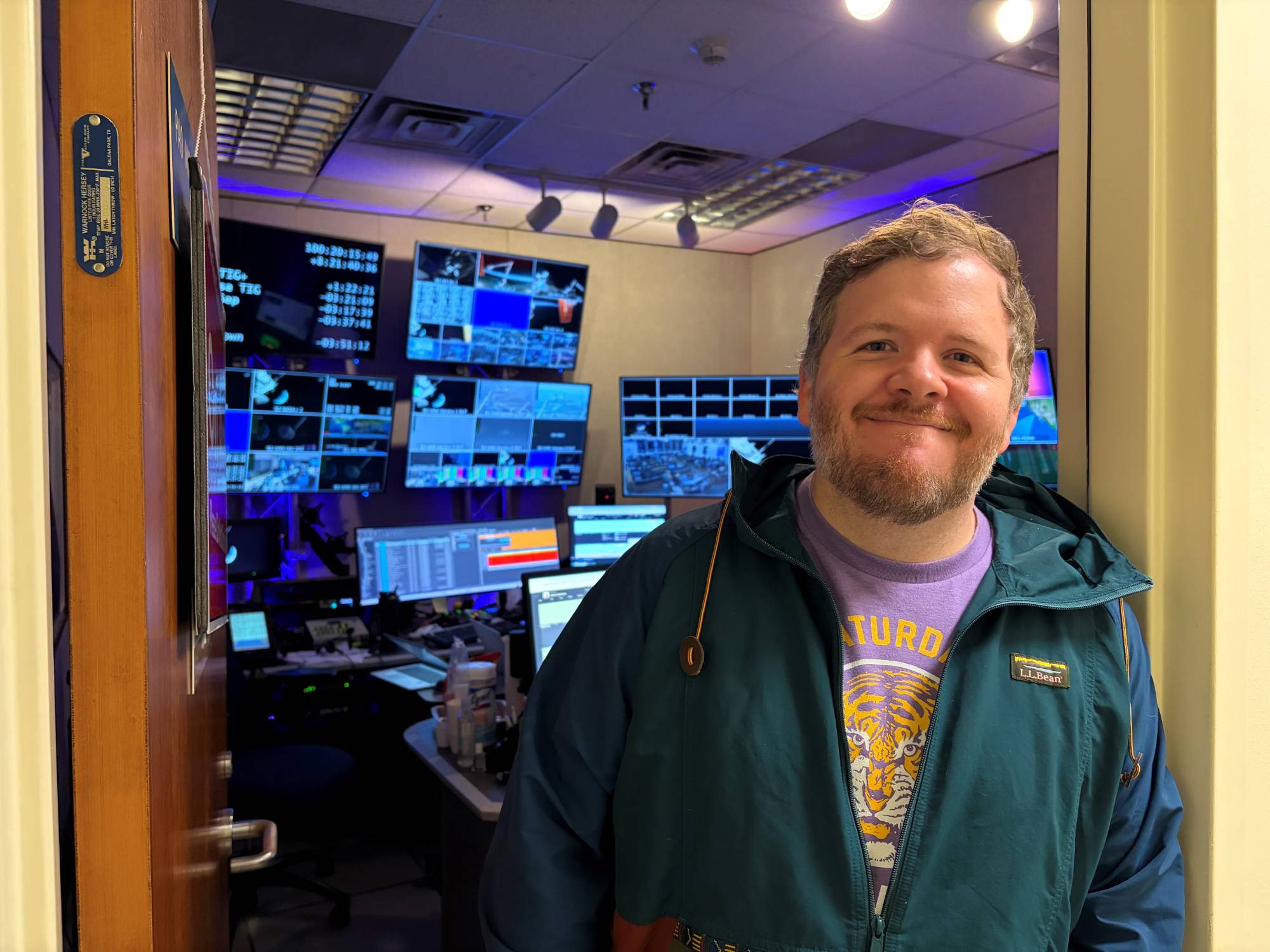 John Hughes, an LSU graduate, stands in front of a studio inside Johnson Space Center