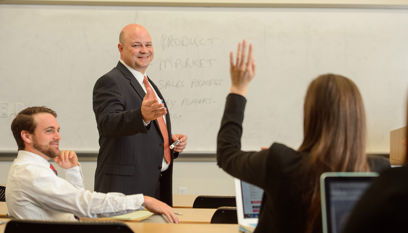 Professor points to student raising her hand.