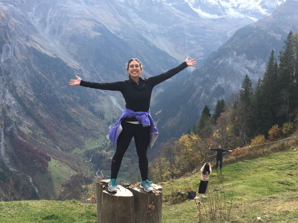 woman standing on a rock with mountiains in the background