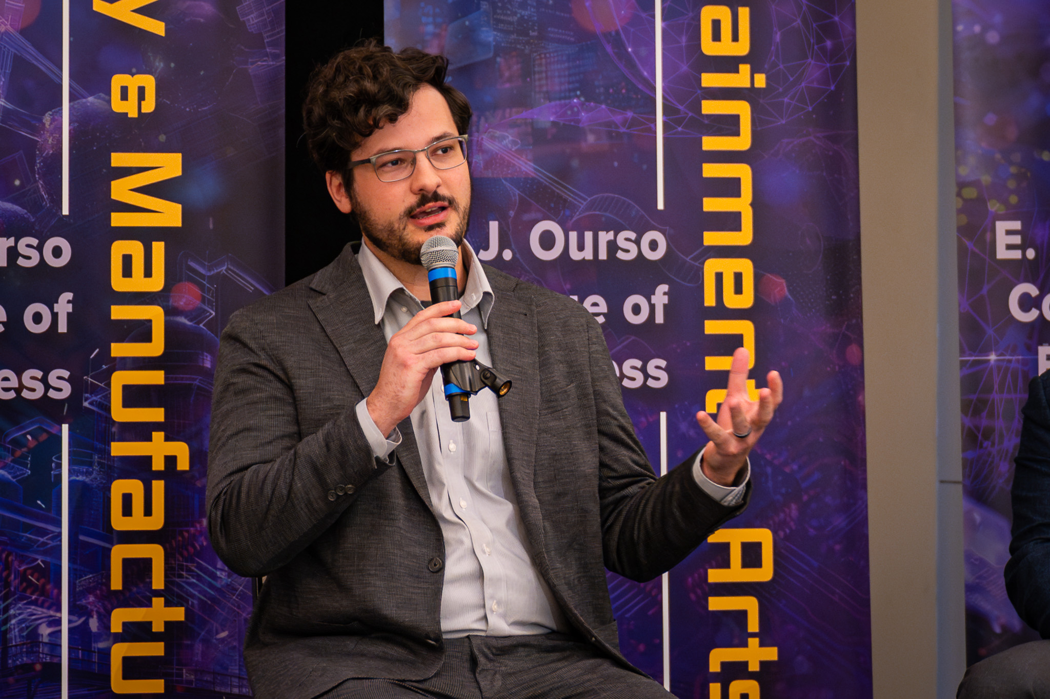 Jude Melville speaking at the AI in Action Symposium.