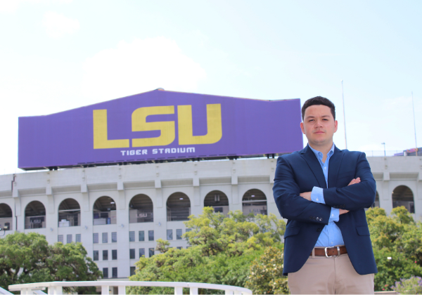 Sport Administration student in front of football stadium