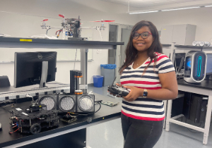 Student in a lab displaying their research project