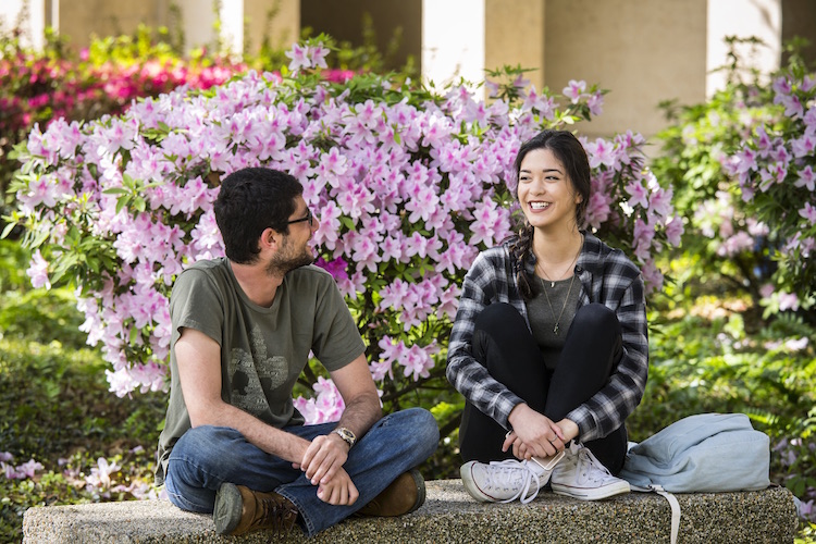 students talking on bench