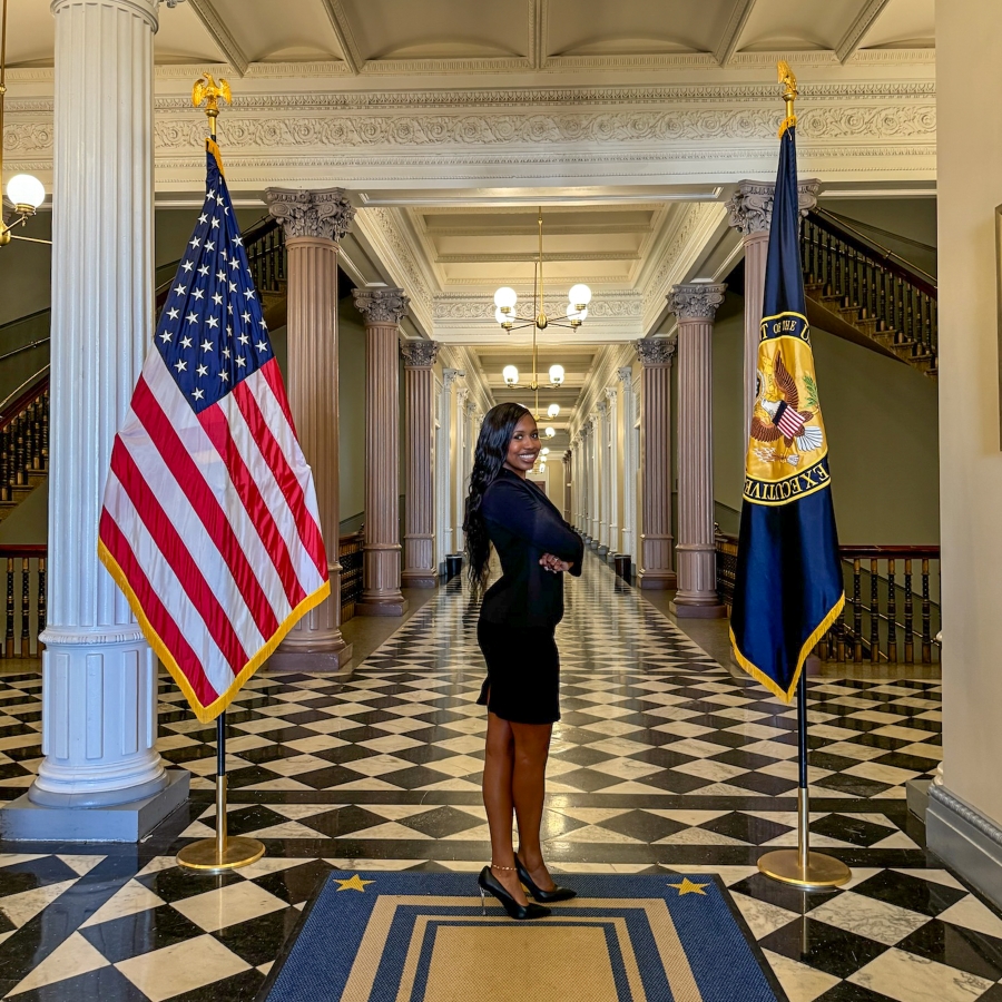 student smiles in White House office building