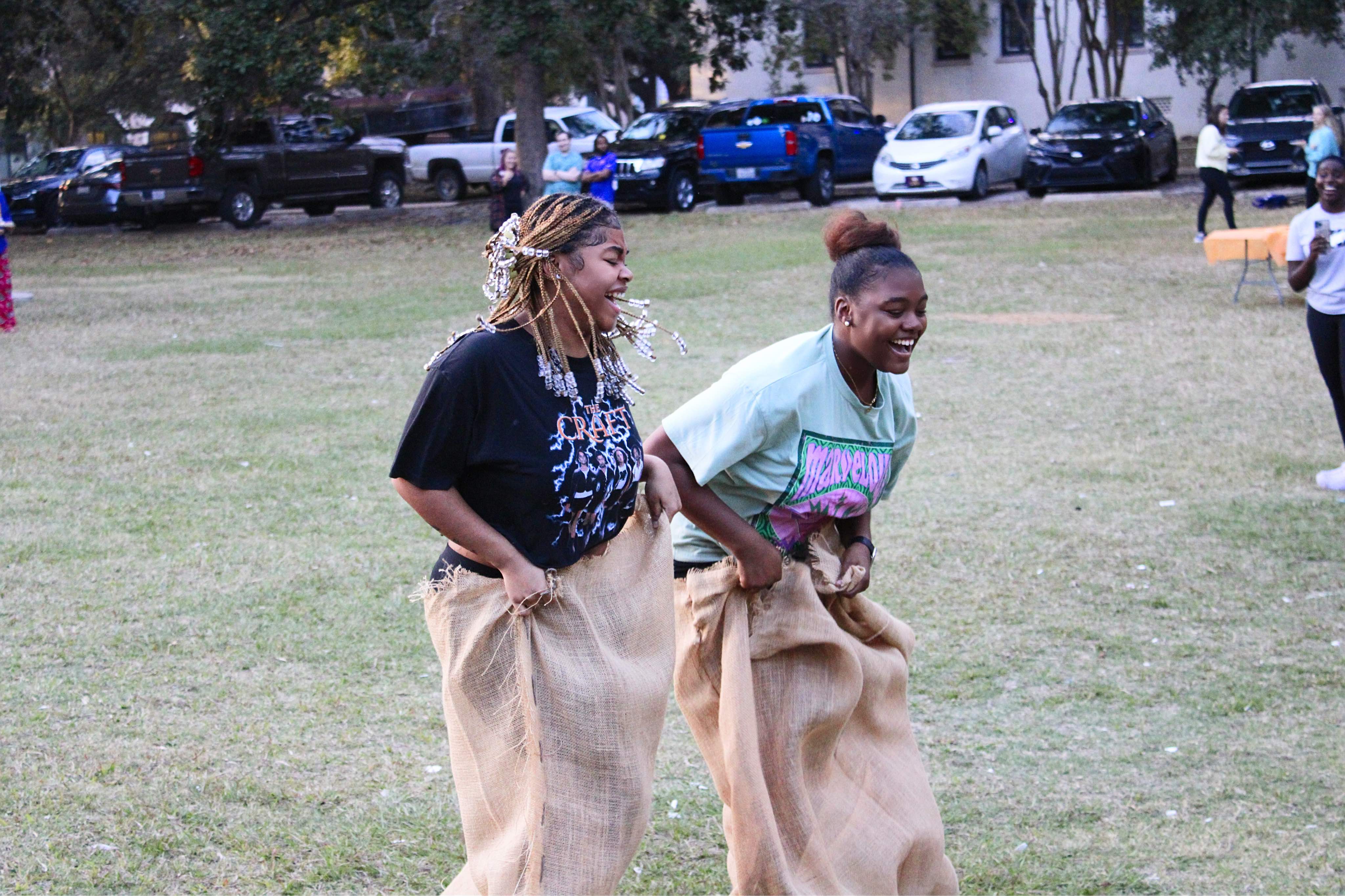 residents competing in a sack race at a community event