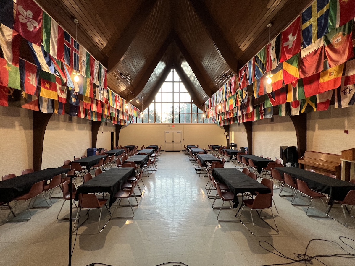 A large event space with flags hanging from the ceiling