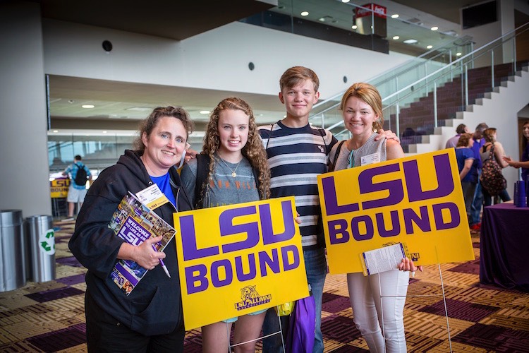 Students holding LSU bound signs