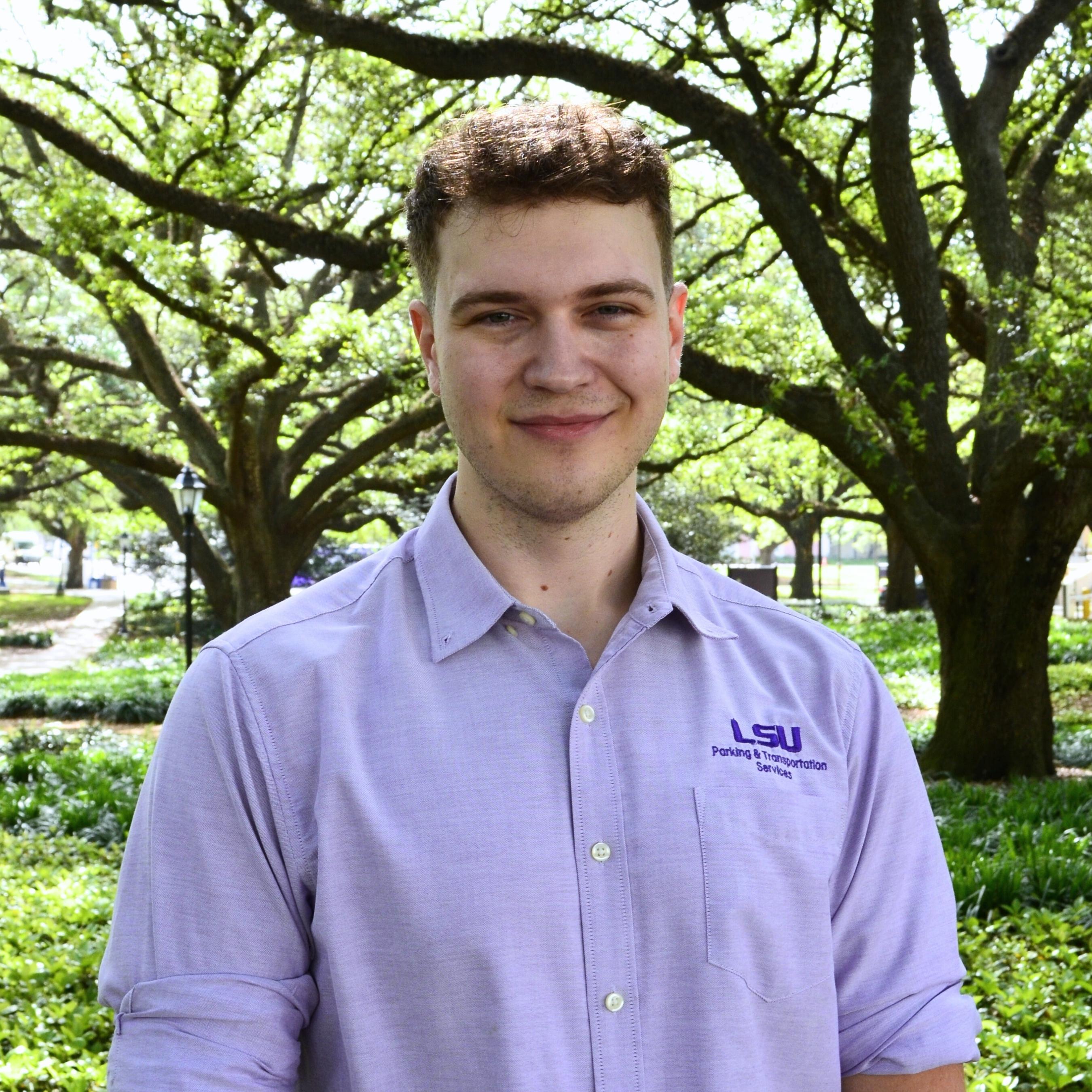 Man in PTS purple polo, smiling