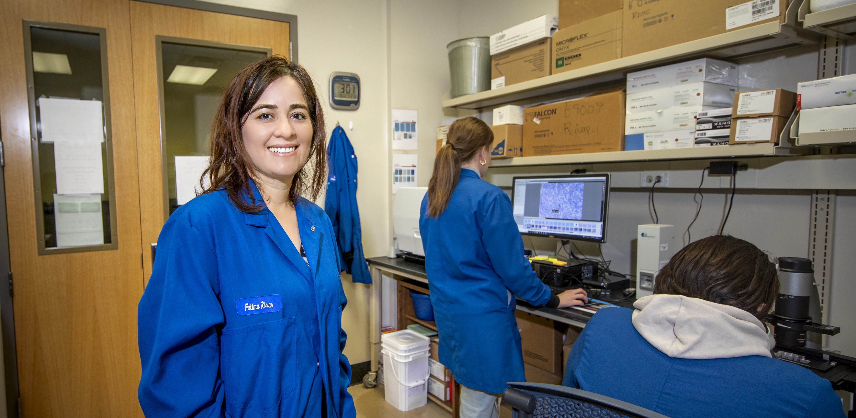 Dr. Rivas in the cell lab with two students