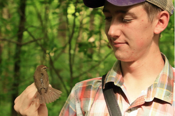 Student holding a bird