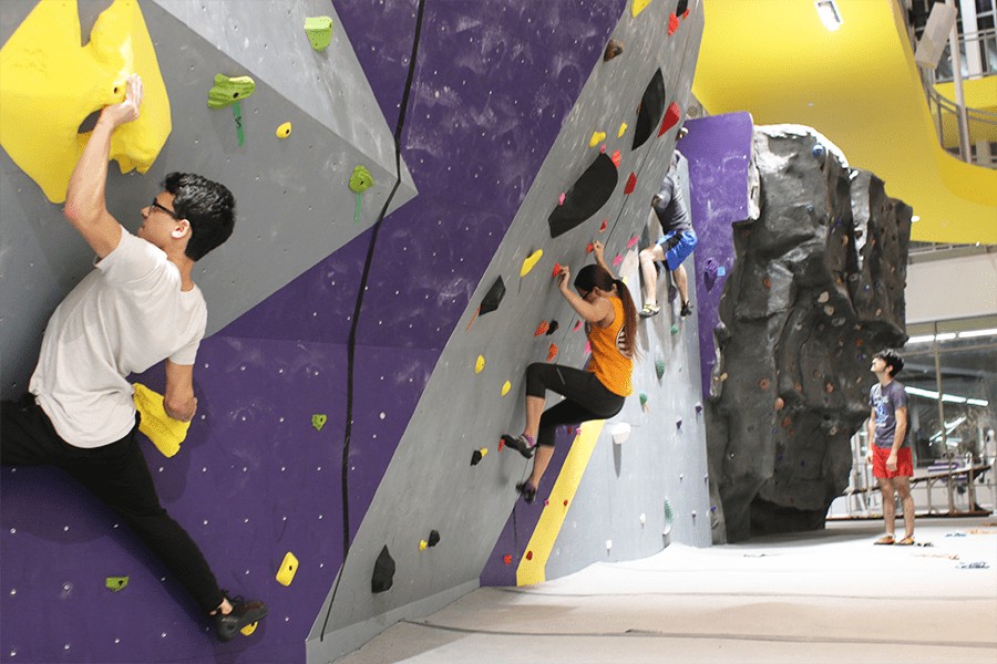 students climbing on the bouldering wall